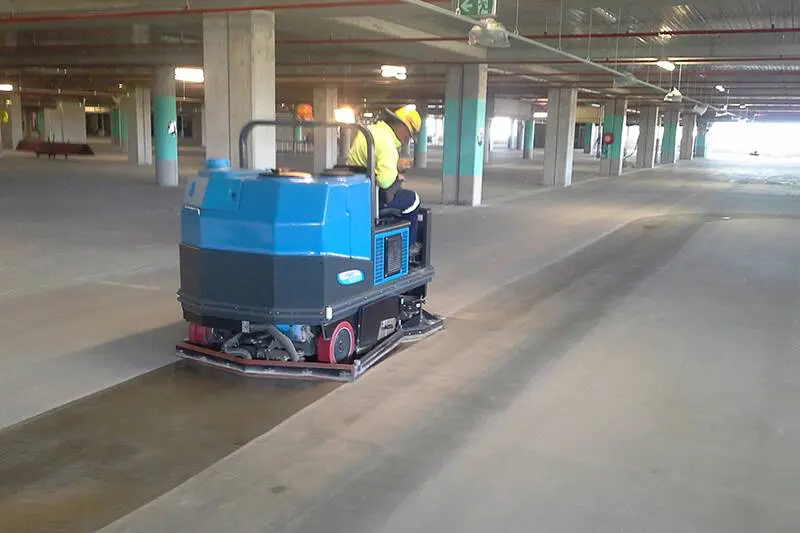 Sweeping machine working a logistics depot slab